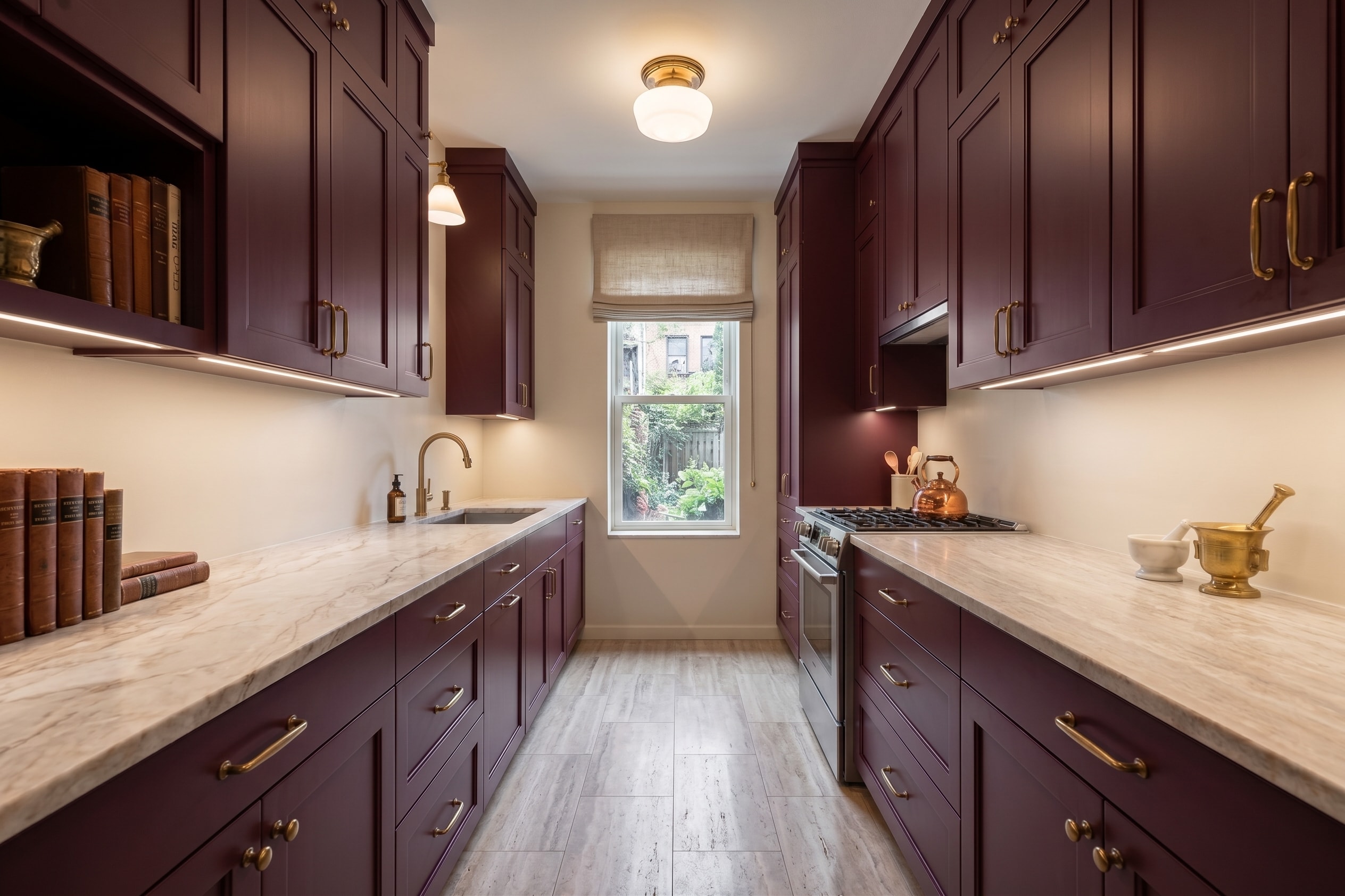 Example narrow kitchen with burgundy cabinets and marble-look counters